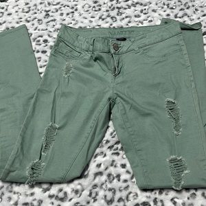 Green distressed skinny jeans